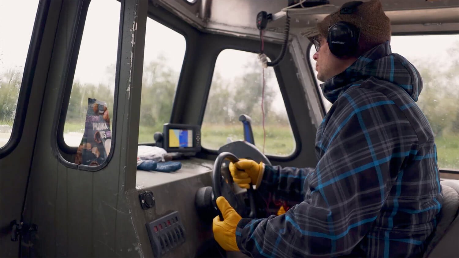Israel Warren in a river boat on the Yukon